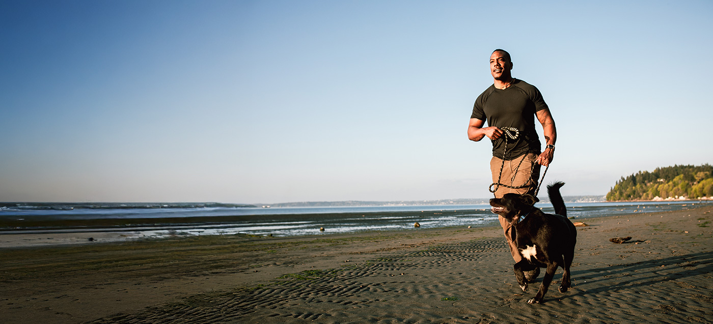 Image of Person Running on Beach with Dog